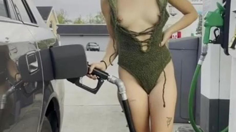 cutie flashes boobs while pumping gas
