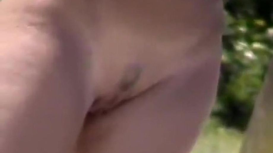 Zooming on a nudist girl's shaved pussy